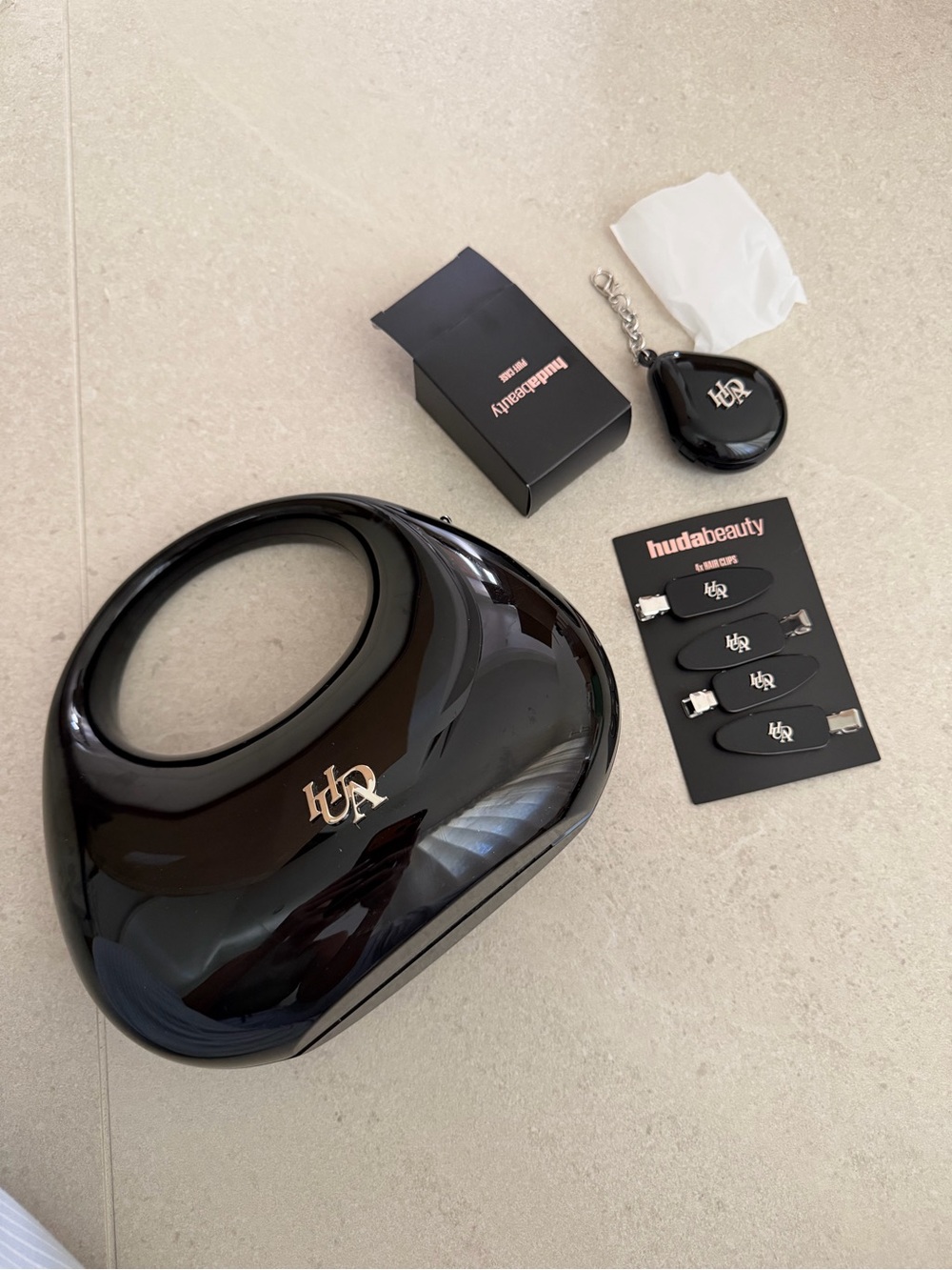Huda Beauty Plastic Makeup Bag Purse with hair clips and puff case